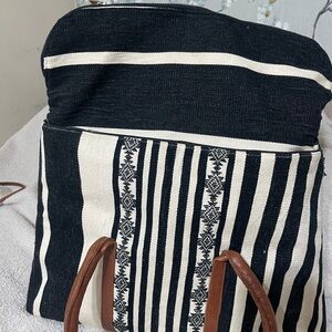 Elegant Black and White Striped Backpack with Brown Accents